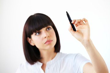 Image showing Business woman, writing and thinking for schedule, planning or strategy against a white studio background. Serious female employee in brainstorming, project plan or tasks for ideas or reminder