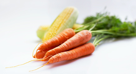 Image showing Vegetable, carrot and corn as healthy food in studio with color, art and creativity for nutritionist. Cooking, wellness diet or nutrition with green or vegan ingredient isolated on a white background