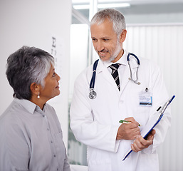 Image showing Senior man doctor with patient, clipboard for information and medical forms during consultation. Healthcare, old woman at checkup and health insurance with communication and help at doctors office