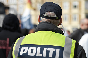 Image showing Law enforcement, protection and security with police officer in crowd for peace, safety and authority. Emergency services, justice and guard with back of person in city for rally, order and arrest