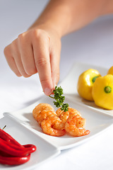 Image showing Hand, prawn and a chef in a restaurant for food serving or luxury hospitality in hotel accommodation. Seafood, shrimp and cooking with a person plating a meal in the kitchen for hunger or nutrition