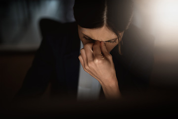 Image showing Headache, stressed businesswoman working late at night and overworked in a office. Burnout or mental health, anxiety and female worker in dark workplace tired or frustrated with hand by face.