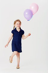 Image showing Smile, balloons and girl playing in studio isolated on a white background mockup space. Happiness, air balloon and kid play games with inflatable toys, having fun and enjoying birthday celebration.