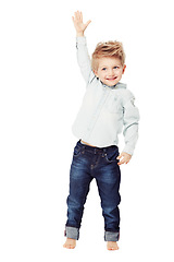 Image showing Children, raised hand and a cute little boy in studio isolated on a white background with a carefree smile. Wow, winner and kids with a young adorable male child raising his arm to ask a question