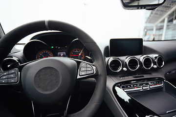 Image showing Control buttons on steering wheel. Car interior.