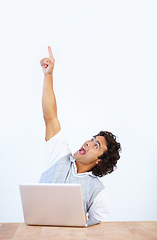 Image showing Celebrate, laptop and businessman pointing up winning, celebrating and isolated in a white studio background. Office desk, winner and male employee or worker showing mockup due to achievement