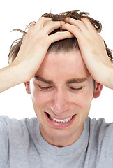 Image showing Man, frustrated crying and loss in studio for mental health problem, depression or pain by white background. Male model, sad student or anxiety with tears, depressed or cry for stress, grief or anger