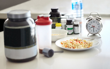 Image showing Table closeup, food and supplement in kitchen for health, diet goal or schedule in home with clock. Meal plan, watch and planning for cooking, preparation or nutrition with drugs, lunch or breakfast