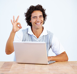 Image showing Portrait, okay and laptop with a business man working at a desk in the office to finish a project. Smile, hand gesture and complete with a happy male employee at work on a computer in the workplace