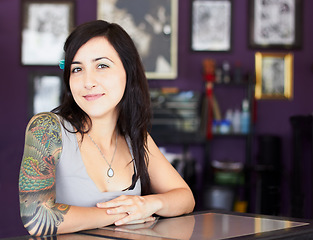 Image showing Tattoos, portrait or woman with arm sleeve of art design, edgy or unique creative style in a shop. Identity, tattoo artist or cool female person with funky ink on skin for creativity or expression