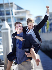 Image showing Celebration, piggyback and corporate couple at harbor excited for success, startup or travel freedom. Business people, victory and man with woman before traveling in Amsterdam, winning and hand sign