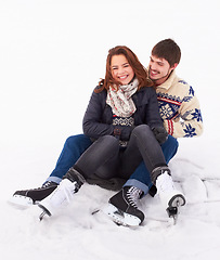 Image showing Couple in the snow, ice skating outdoor with happiness and spending quality time together, relax in winter weather. Happy people cuddling, skate on frozen lake and bond in nature with love and care