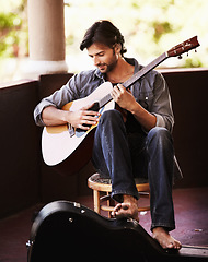 Image showing Music, art and man playing guitar with musical talent for practice for a performance or concert. Performer, outdoor and male musician, guitarist or artist performing a song on a string instrument.