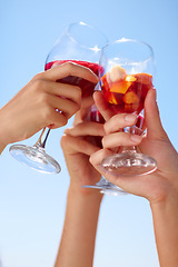 Image showing Hands, cocktail toast and friends outdoor for celebration of friendship together. Alcohol, glass and group cheers to celebrate at summer party, event or social gathering for drinking in low angle.