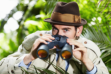 Image showing Detective man, search and portrait in jungle with vintage gear for investigation and solution. Outdoor, private investigator and spy with binoculars for surveillance and retro reporter character