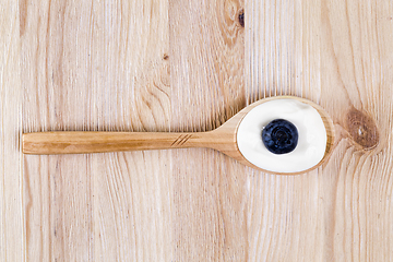 Image showing sour cream and blueberries in a spoon