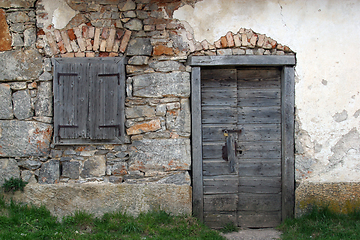 Image showing Wooden door and window on stone facade.