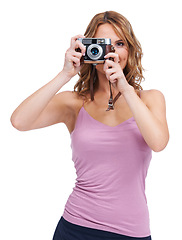 Image showing Photography, camera and portrait of woman photographer taking a picture isolated in a studio white background. Vintage, retro and creative female person or professional shooting with focus and lens