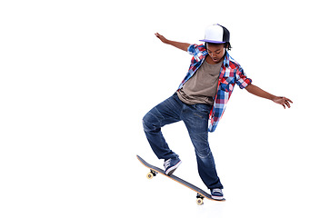 Image showing Skateboard, black boy and kid in a studio with mockup and jump trick with young style. Isolated, white background and African male child with a skateboarding and skater with energy and skill