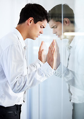 Image showing Work, thinking and a man at a window with stress, corporate burnout and tired with reflection. Anxiety, depression and a businessman looking depressed or frustrated while working in the office