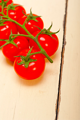 Image showing fresh cherry tomatoes on a cluster