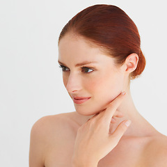 Image showing Skincare, thinking and woman touch face in white background, isolated studio and natural beauty. Female model, facial glow and makeup cosmetics for aesthetic dermatology, self love and transformation