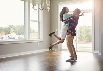 Image showing Happy couple, moving into their new home and hug for mortgage or property buy or together in empty lounge and romance. Real estate, man and woman excited or embrace and romance in the living room