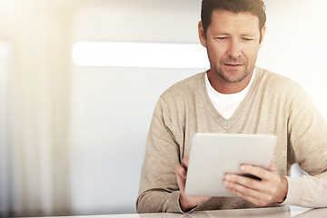 Image showing Social networking, mature and man with tablet and at table at his home. Blog or internet connectivity, technology and mockup space with male person reading an email or report at desk his house.