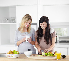 Image showing Food, friends and women in a kitchen with salad, vegetables and bonding in their home together. Fruit, vegetarian and females preparing healthy snack for lunch, talking and happy in their apartment