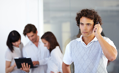 Image showing Phone call, office and business man with team in serious conversation, discussion and networking. Communication, corporate and male worker on cellphone talking, speaking and connection in workplace