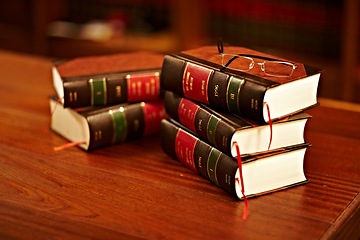 Image showing Legal books, glasses and lawyer research textbook in a student library with no people. Justice, knowledge and judge book for investigation and attorney work in archive and university law department