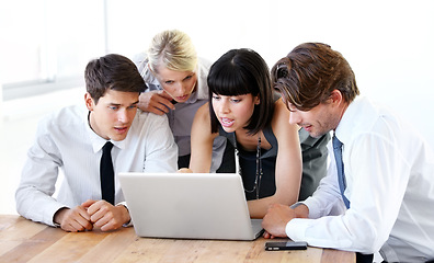 Image showing Collaboration, laptop or research with a business team in the boardroom, working together on a project. Teamwork, planning or strategy with men and women employees at work in the office on a computer