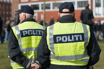 Image showing Safety, protection and security with police officer in city for peace, law enforcement and authority. Emergency services, justice and guard with person in street for enforcement, order and arrest