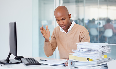 Image showing Stress, documents and burnout with a business black man in an office, sitting at a desk while working on a problem. Audit, tax and compliance with a young male employee suffering from anxiety at work