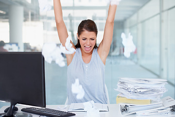 Image showing Business woman, stress and throwing paper in air for workload by office desk. Angry, upset or frustrated female employee overworked or under pressure with documents and paperwork at the workplace