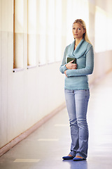 Image showing Portrait, woman and teacher in a hallway, standing and education with knowledge in a school. Face, female person and educator in a lobby, serious and teaching with confidence, growth and mindset