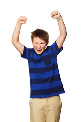 Image showing Portrait, celebration and excited kid with hands raised in studio isolated on a white background. Boy, winner and happy child celebrate achievement, success or winning, happiness and victory.