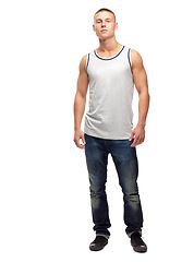 Image showing Man, confident and portrait with fashion and modern style in a studio. White background, jeans and young male model with muscles and clothing with youth and attitude feeling proud with confidence