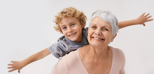 Image showing Airplane, smile and portrait of grandmother with child embrace, happy and bond on wall background. Love, face and senior woman with grandchild having fun playing, piggyback and enjoying game together