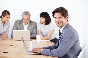 Image showing Business man in portrait with laptop, leadership in meeting and corporate leader in conference room. Confident male typing notes with smile, presentation and technology with pride in workplace