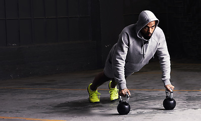 Image showing Kettlebell training, mockup and a man athlete during his workout for strength while looking serious. Fitness, focus and weightlifting with a male bodybuilder in a dark studio for physical exercise