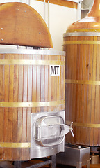 Image showing Brewery, machine and barrel for beer, alcohol and brewing process with a tap. Wooden, drum and alcoholic beverage at a distillery for storage, fermentation and manufacturing, industry or system