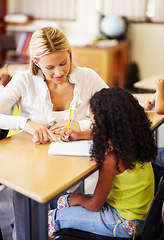 Image showing Teaching, writing and teacher helping child at school with education, learning or development. Woman talking to girl student with notebook, pencil and knowledge at classroom desk with support