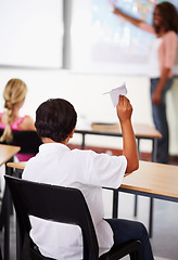 Image showing Student, paper plane and classroom with teacher and children, learning at desks or young boy, distraction and play with origami airplane. Naughty kid, holding jet and middle school education