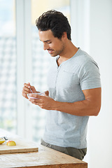 Image showing Health, diet and man eating a fruit salad for breakfast, lunch or a healthy meal in his kitchen. Nutrition, wellness and male person enjoying a organic, natural and vitality food in his modern house.