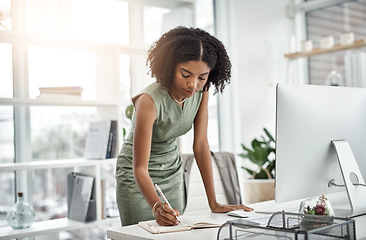 Image showing Computer, planning and business woman writing and working by her desk or table in a corporate startup company. Internet, online and professional female employee or African worker with a schedule book