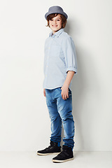 Image showing Cool, stylish and portrait of a child in fashion isolated on a white background in a studio. Happy, fashionable and a young boy model in jeans and clothes for style, happiness and confidence