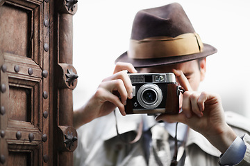 Image showing Detective, camera and spy with man in studio for surveillance, reporter and investigation. Photography, press and secret with male agent on white background for vintage, paparazzi and journalist