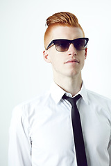 Image showing Stylish, ginger and a man with sunglasses and thinking while isolated on a white background in a studio. Idea, fashionable and a young employee in professional clothes with eyewear for business