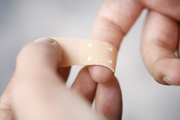 Image showing Bandaging finger